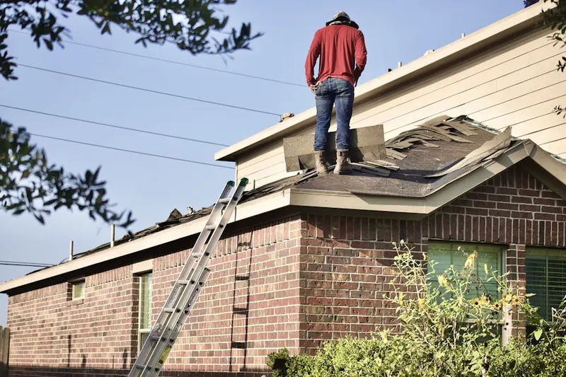 Professional roofer working on a residential roof in Wilmette